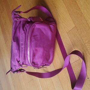 TUMI crossbody fuchsia bag with four compartments
